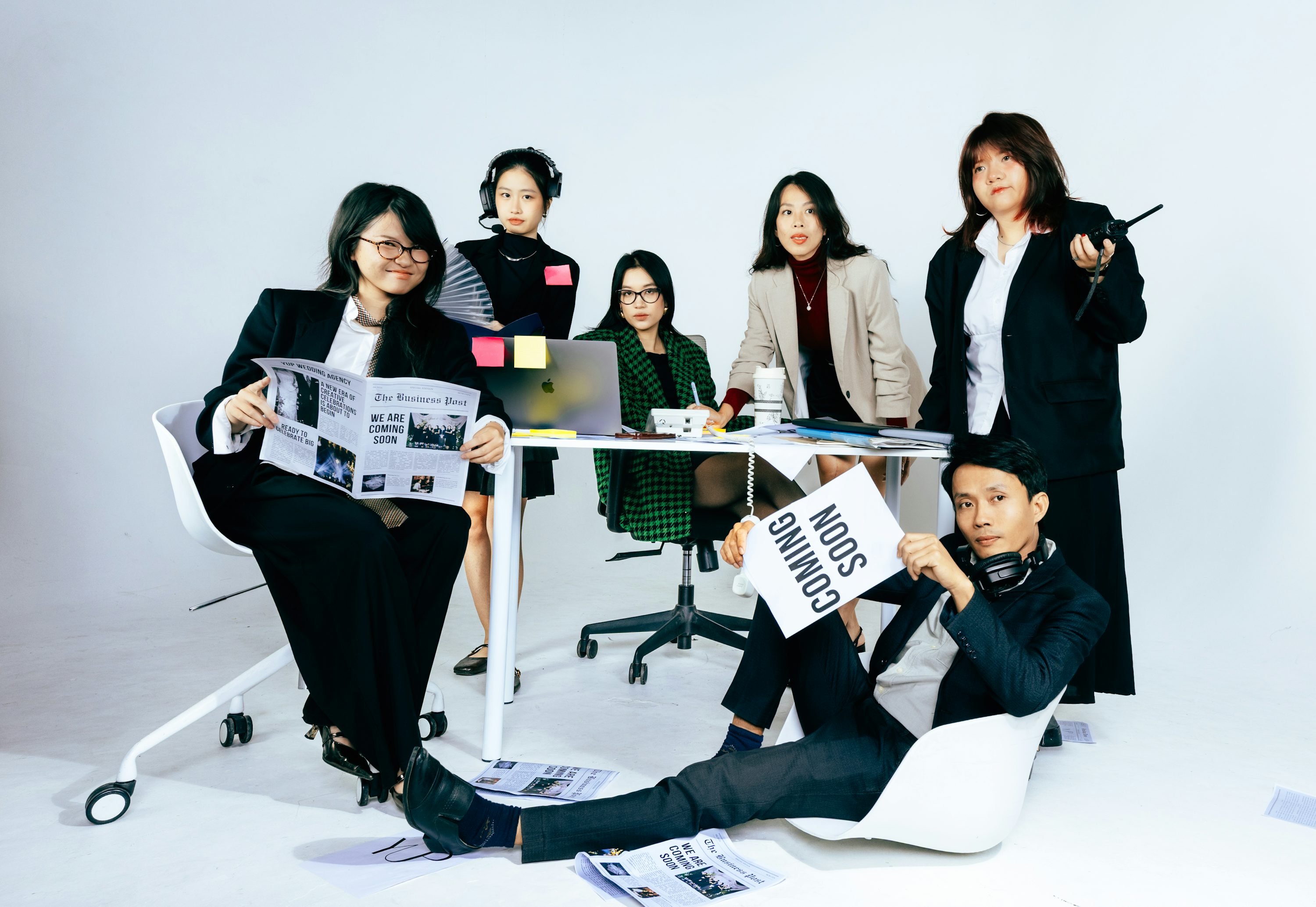 A diverse group of people in business attire posing.