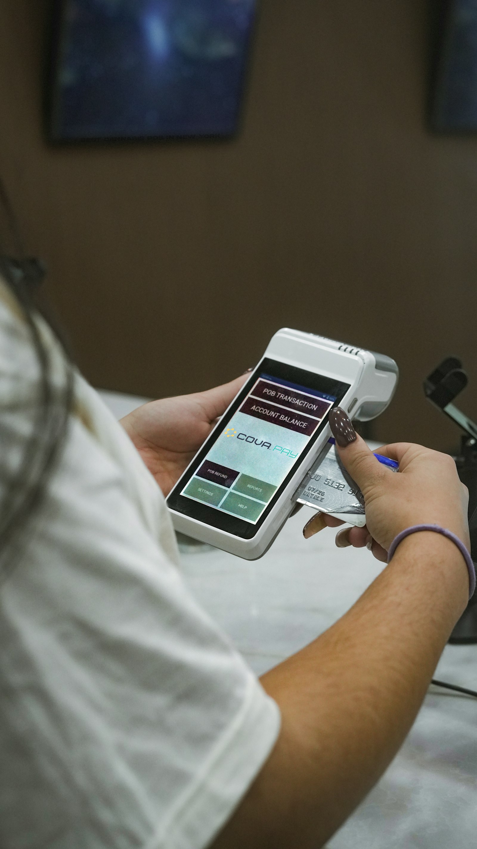 A person using a credit card on a payment terminal, representing card payment security for a startup