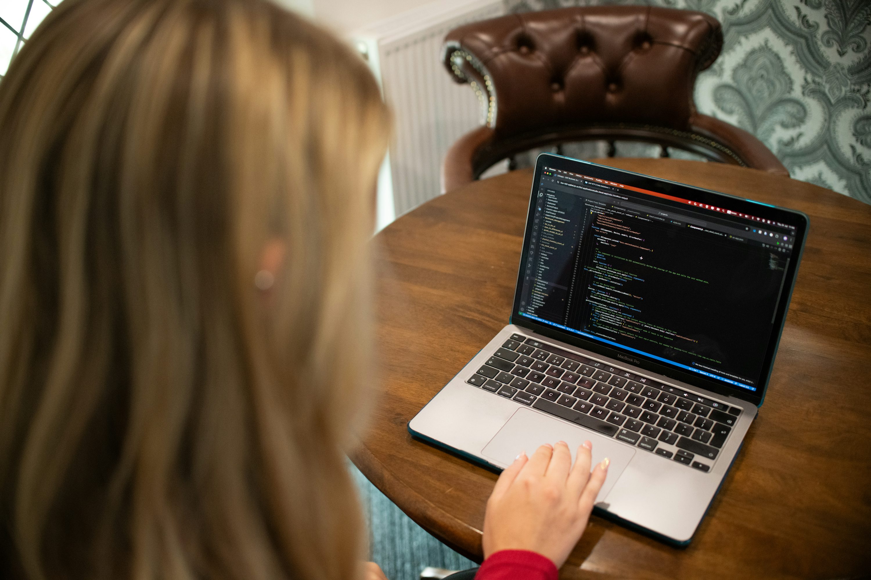 A developer typing code on a laptop.