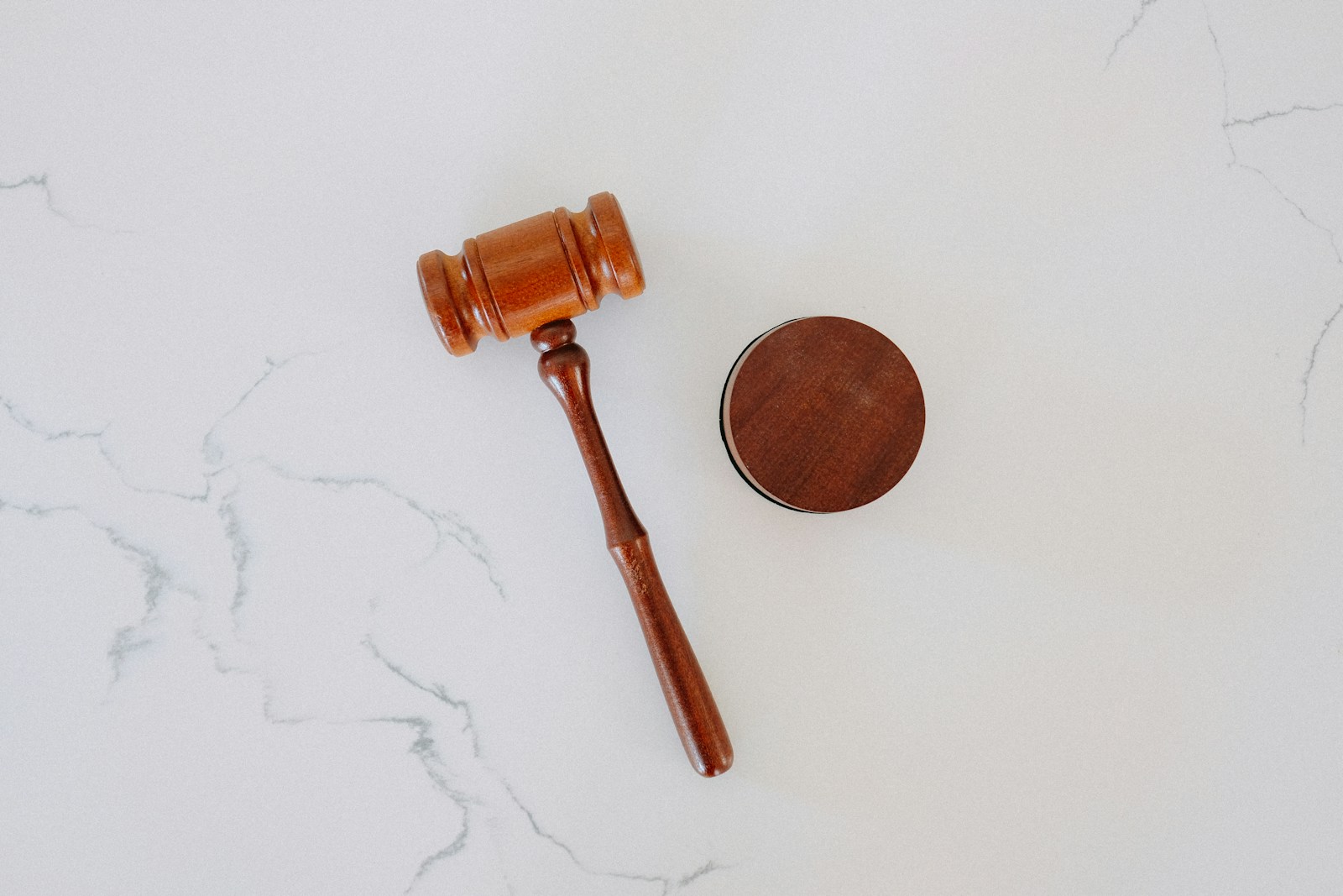 A wooden gavel and block on marble, representing DMCA safe harbor rules for online services